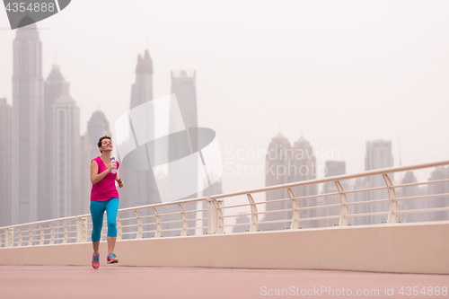 Image of woman running on the promenade