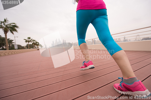 Image of woman running on the promenade