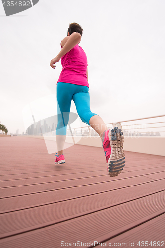 Image of woman running on the promenade