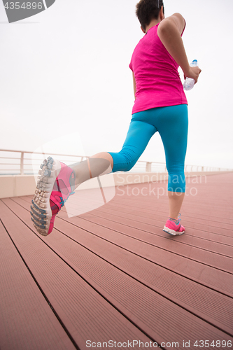 Image of woman busy running on the promenade