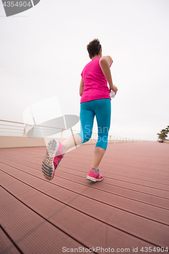 Image of woman busy running on the promenade