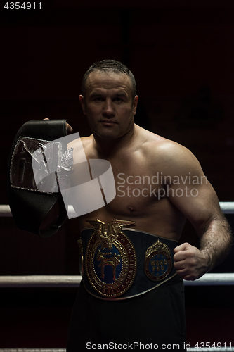 Image of kick boxer with his championship belt