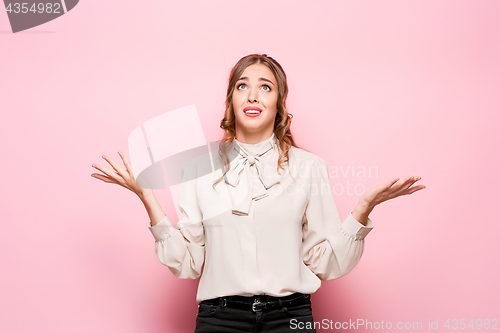 Image of Portrait of young woman with shocked facial expression