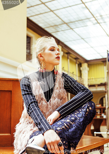 Image of young attractive fashion lady on railway station waiting, vintag