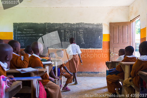 Image of Children in uniforms in primary school classroom listetning to teacher in rural area near Arusha, Tanzania, Africa.