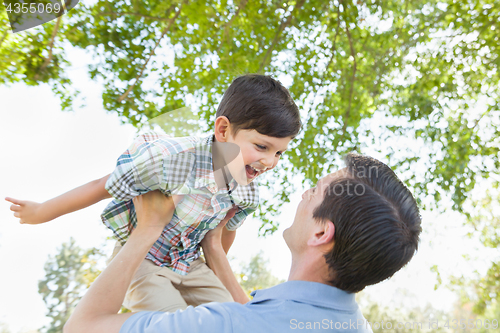 Image of Happy Caucasian Father and Son Playing Together in the Park.