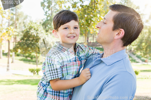 Image of Happy Caucasian Father and Son Playing Together in the Park.