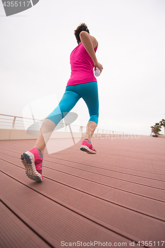 Image of woman busy running on the promenade