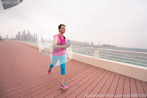 Image of woman running on the promenade