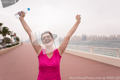 Image of young woman celebrating a successful training run