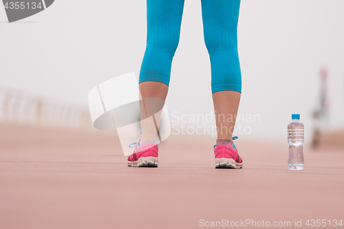 Image of close up on running shoes and bottle of water