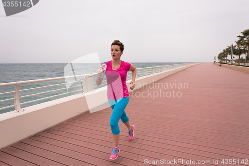 Image of woman busy running on the promenade