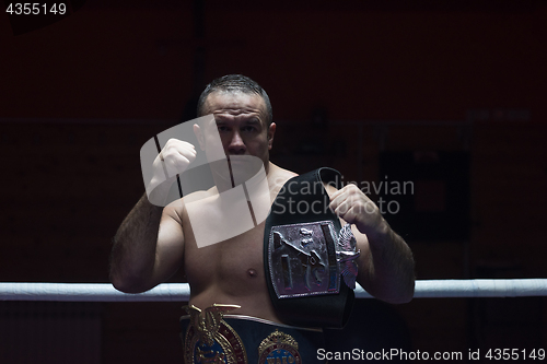 Image of kick boxer with his championship belt