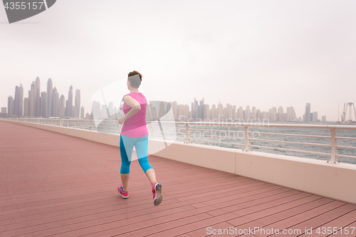 Image of woman running on the promenade