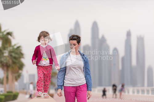 Image of mother and cute little girl on the promenade