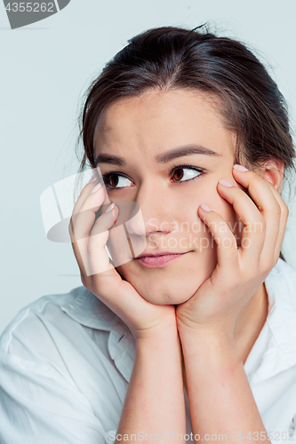 Image of The young woman\'s portrait with thoughtful emotions