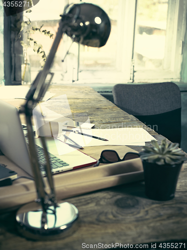 Image of Vintage hipster wooden desktop side view