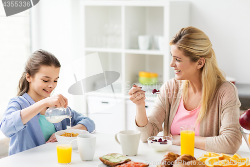 Image of happy family having breakfast at home kitchen