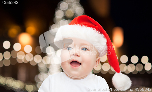 Image of little baby boy in santa hat at christmas