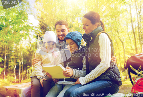 Image of happy family with tablet pc and backpacks at camp