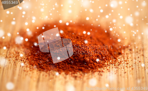 Image of cayenne pepper or paprika powder on wood