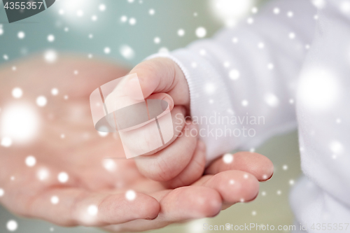 Image of close up of mother and newborn baby hands