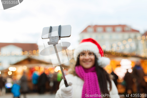 Image of woman taking selfie with smartphone at christmas 