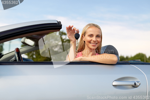 Image of happy young woman with convertible car key