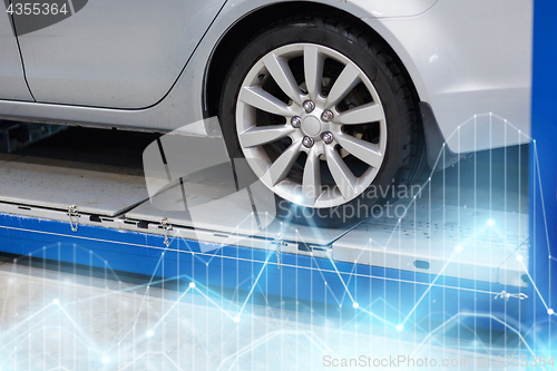 Image of car on lift at repair station