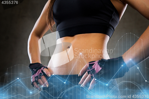 Image of young woman body in gym