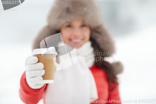 Image of happy woman with coffee cup in winter