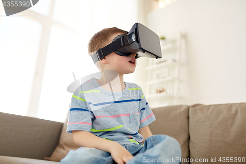 Image of little boy in vr headset or 3d glasses at home