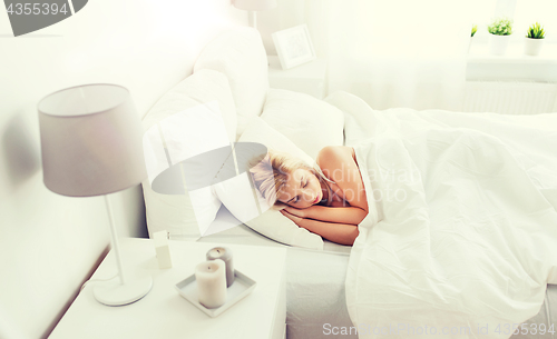 Image of young woman sleeping in bed at home bedroom