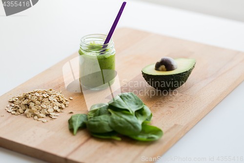 Image of jar with puree or baby food on wooden board