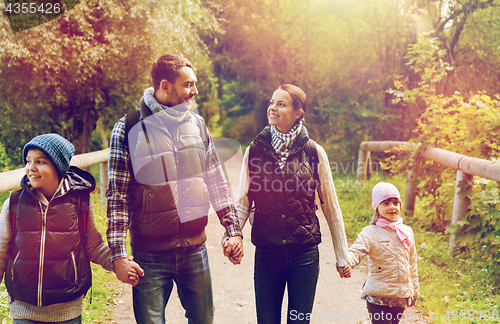 Image of happy family with backpacks hiking