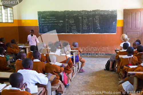 Image of Children in uniforms in primary school classroom listetning to teacher in rural area near Arusha, Tanzania, Africa.