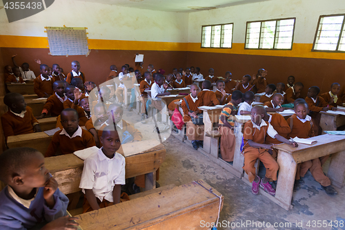 Image of Children in uniforms in primary school classroom listetning to teacher in rural area near Arusha, Tanzania, Africa.