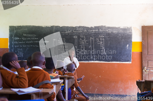 Image of Children in uniforms in primary school classroom listetning to teacher in rural area near Arusha, Tanzania, Africa.