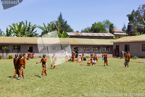 Image of Children in uniforms playing in the cortyard of primary school in rural area near Arusha, Tanzania, Africa.