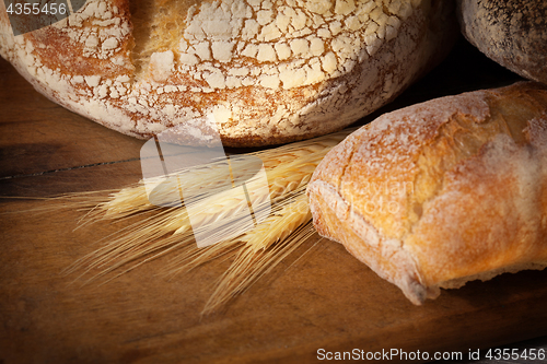 Image of Fresh homemade bread assortment on old cutting board