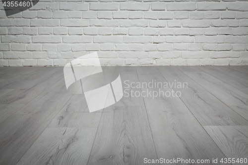 Image of Old white brick wall and wood floor background