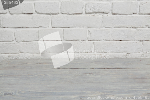 Image of Old white brick wall and wood floor background