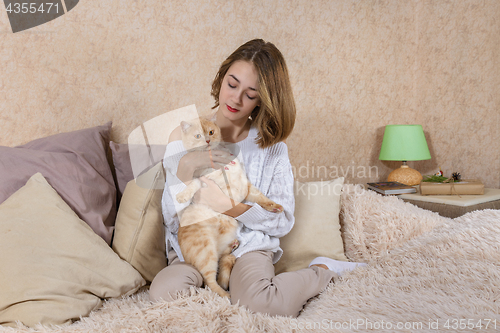 Image of The girl with red cat