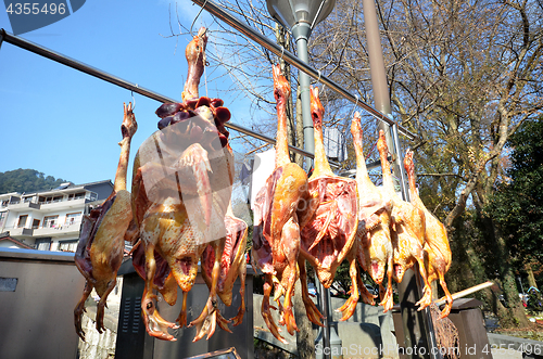 Image of Rows of cured meat hanging to dry