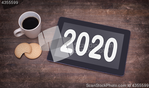 Image of Tablet touch computer gadget on wooden table - 2020