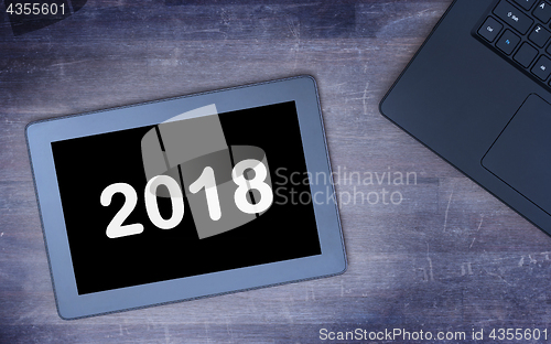 Image of Tablet touch computer gadget on wooden table - 2018