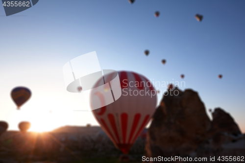 Image of Blurred view on hot air balloons and blue clear sunlight sky and