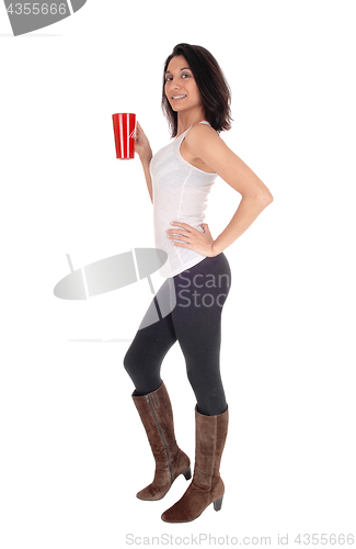 Image of Beautiful Hispanic woman with red coffee mug.