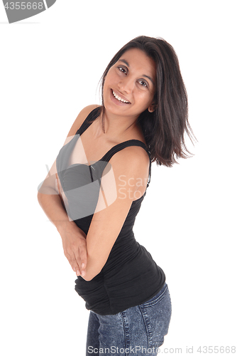 Image of Woman standing in profile in full length.