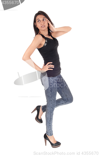 Image of Woman standing in profile in full length.
